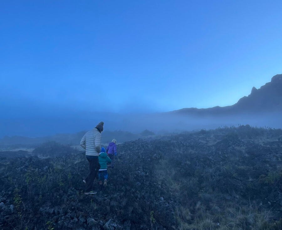 Family on coastal lava rocks